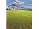 Spacious backyard featuring a well-maintained lawn and privacy fence at 520 Harmony Way, Locust Grove, GA 30248