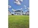Expansive backyard view showcasing the home's exterior and lush green lawn at 520 Harmony Way, Locust Grove, GA 30248