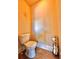 Small half bathroom with tile floor and toilet, featuring roll paper holder with extra paper at 520 Harmony Way, Locust Grove, GA 30248