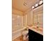 Bright bathroom features a large mirror, vanity, and a shower-tub combination at 520 Harmony Way, Locust Grove, GA 30248