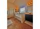 Bright bathroom featuring a soaking tub, large vanity with double sinks, and window for natural light at 520 Harmony Way, Locust Grove, GA 30248