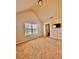 Upstairs bedroom with ensuite bathroom, neutral carpet, and a large window at 520 Harmony Way, Locust Grove, GA 30248