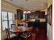 Kitchen nook and dining area boasting dark wood floors and natural light at 520 Harmony Way, Locust Grove, GA 30248