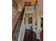 Elegant foyer with hardwood floors, staircase with iron railing, and decorative wainscoting at 520 Harmony Way, Locust Grove, GA 30248