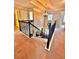 Upstairs hallway with staircase featuring carpeted steps and iron railing with open doorways at 520 Harmony Way, Locust Grove, GA 30248