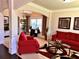 Inviting living room with red sofas, decorative columns, and bright natural light at 520 Harmony Way, Locust Grove, GA 30248