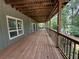 Long wooden deck with railings, offering ample outdoor space and nature views at 722 Beauregard Sw Dr, Marietta, GA 30064