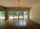 Bright dining room with a hardwood floor, modern light fixture, and glass doors to a deck at 722 Beauregard Sw Dr, Marietta, GA 30064