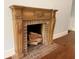 Elegant fireplace with a decorative wooden mantel and brick surround; ready for a cozy fire at 722 Beauregard Sw Dr, Marietta, GA 30064