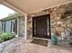 Elegant stone entryway with a carved wooden front door and decorative accents at 722 Beauregard Sw Dr, Marietta, GA 30064