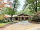 Ranch home with stone accents, front porch, and a driveway with stone walkway and mature landscaping at 722 Beauregard Sw Dr, Marietta, GA 30064