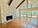 Cozy living room with stone fireplace, hardwood floors, and large windows with outdoor views at 722 Beauregard Sw Dr, Marietta, GA 30064