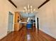 Open-concept living room featuring a hardwood floor, beam, and a view into the kitchen at 722 Beauregard Sw Dr, Marietta, GA 30064