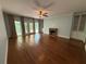 Open living room with hardwood floors, fireplace, and access to an outdoor balcony with natural light at 722 Beauregard Sw Dr, Marietta, GA 30064