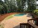 Inviting backyard pool area featuring a brick paver patio, privacy fence and lush landscaping at 722 Beauregard Sw Dr, Marietta, GA 30064