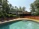 Backyard with a sparkling pool, lounge chairs, and a wooden fence for privacy at 722 Beauregard Sw Dr, Marietta, GA 30064