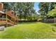 View of the backyard and the elevated deck with stairs down to the yard at 920 Highfield Ct, Lawrenceville, GA 30043