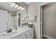 Bathroom area featuring a single sink vanity, decorative lighting, and a shower-tub combo at 920 Highfield Ct, Lawrenceville, GA 30043