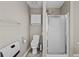 Clean bathroom featuring a shower, toilet, cabinet, and neutral wall paint at 920 Highfield Ct, Lawrenceville, GA 30043