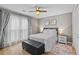 Comfortable bedroom with natural light, a ceiling fan, hardwood floors, and ensuite bathroom at 920 Highfield Ct, Lawrenceville, GA 30043