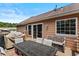 A view of an outdoor deck with grill and furniture, with sliding glass doors to home at 920 Highfield Ct, Lawrenceville, GA 30043