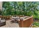 Outdoor deck featuring wood railing, furniture and grill, surrounded by mature trees at 920 Highfield Ct, Lawrenceville, GA 30043