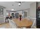 Bright dining area featuring an oval wooden table, white chairs, and an adjacent kitchen with stainless steel appliances at 920 Highfield Ct, Lawrenceville, GA 30043