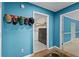 Hallway displaying blue walls with hat rack near laundry room with modern appliances at 920 Highfield Ct, Lawrenceville, GA 30043