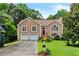 Beautiful two-story home with a red front door and lush green lawn at 920 Highfield Ct, Lawrenceville, GA 30043