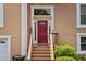Close-up of the red front door with sidelights and wooden steps leading up at 920 Highfield Ct, Lawrenceville, GA 30043