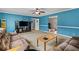 Cozy living room with blue walls, carpet, and access to multiple rooms; furnished with couches and a coffee table at 920 Highfield Ct, Lawrenceville, GA 30043