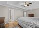 Serene main bedroom with tray ceilings, hardwood floors, and ensuite bathroom at 920 Highfield Ct, Lawrenceville, GA 30043