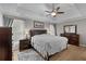 Spacious main bedroom boasts a tray ceiling, a large bed, and matching dark wood furniture at 920 Highfield Ct, Lawrenceville, GA 30043