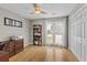 Bright office featuring wood floors, a ceiling fan, a bookshelf, and sliding glass doors with natural light at 920 Highfield Ct, Lawrenceville, GA 30043