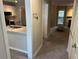 Galley kitchen featuring white cabinets, stainless appliances, and a view into the living space at 1130 Weatherstone Ne Dr, Atlanta, GA 30324