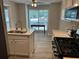Bright eat-in kitchen with stainless appliances, quartz countertops, and view of backyard at 1130 Weatherstone Ne Dr, Atlanta, GA 30324