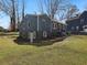 Backyard featuring a dark blue house with light trim and a sloped yard of green grass at 1406 Kennesaw Nw Dr, Atlanta, GA 30318