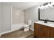 Modern bathroom with stylish vanity, mirror, and tub-shower combination at 1406 Kennesaw Nw Dr, Atlanta, GA 30318