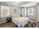 Comfortable bedroom features a large bed, hardwood floors, natural light from windows, and modern decor at 1406 Kennesaw Nw Dr, Atlanta, GA 30318