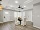 Modern dining room features a glass table, four chairs, tray ceiling with ceiling fan, and hardwood flooring at 1406 Kennesaw Nw Dr, Atlanta, GA 30318