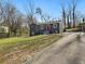 Home exterior with a gray facade, a red door, a well-maintained lawn, and a long driveway at 1406 Kennesaw Nw Dr, Atlanta, GA 30318
