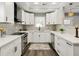 Modern kitchen with white cabinets, stainless appliances, granite counters, and a view from the window at 1406 Kennesaw Nw Dr, Atlanta, GA 30318
