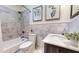 Modern bathroom features a marble tiled tub, shower, and sink at 147 Olympic Pl, Decatur, GA 30030