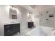 Stylish bathroom with double vanity, soaking tub, and tiled shower at 147 Olympic Pl, Decatur, GA 30030
