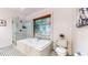 Well-appointed bathroom with a soaking tub, shower, and black and white tile at 147 Olympic Pl, Decatur, GA 30030