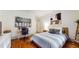 Bedroom showcasing warm wood floors, accent art, a writing desk and a comfortable sleeping area at 147 Olympic Pl, Decatur, GA 30030