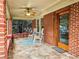 Inviting front porch with stone floor, rocking chairs, brick columns, and decorative glass door at 147 Olympic Pl, Decatur, GA 30030