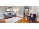 Well-lit living room with hardwood floors, stylish furniture, and a view into the next room at 147 Olympic Pl, Decatur, GA 30030