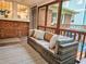 Covered porch with wicker furniture and brick wall detail offer additional outdoor living space at 147 Olympic Pl, Decatur, GA 30030