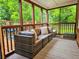 A cozy screened porch with wood columns and an outdoor sectional provides a relaxing space at 147 Olympic Pl, Decatur, GA 30030